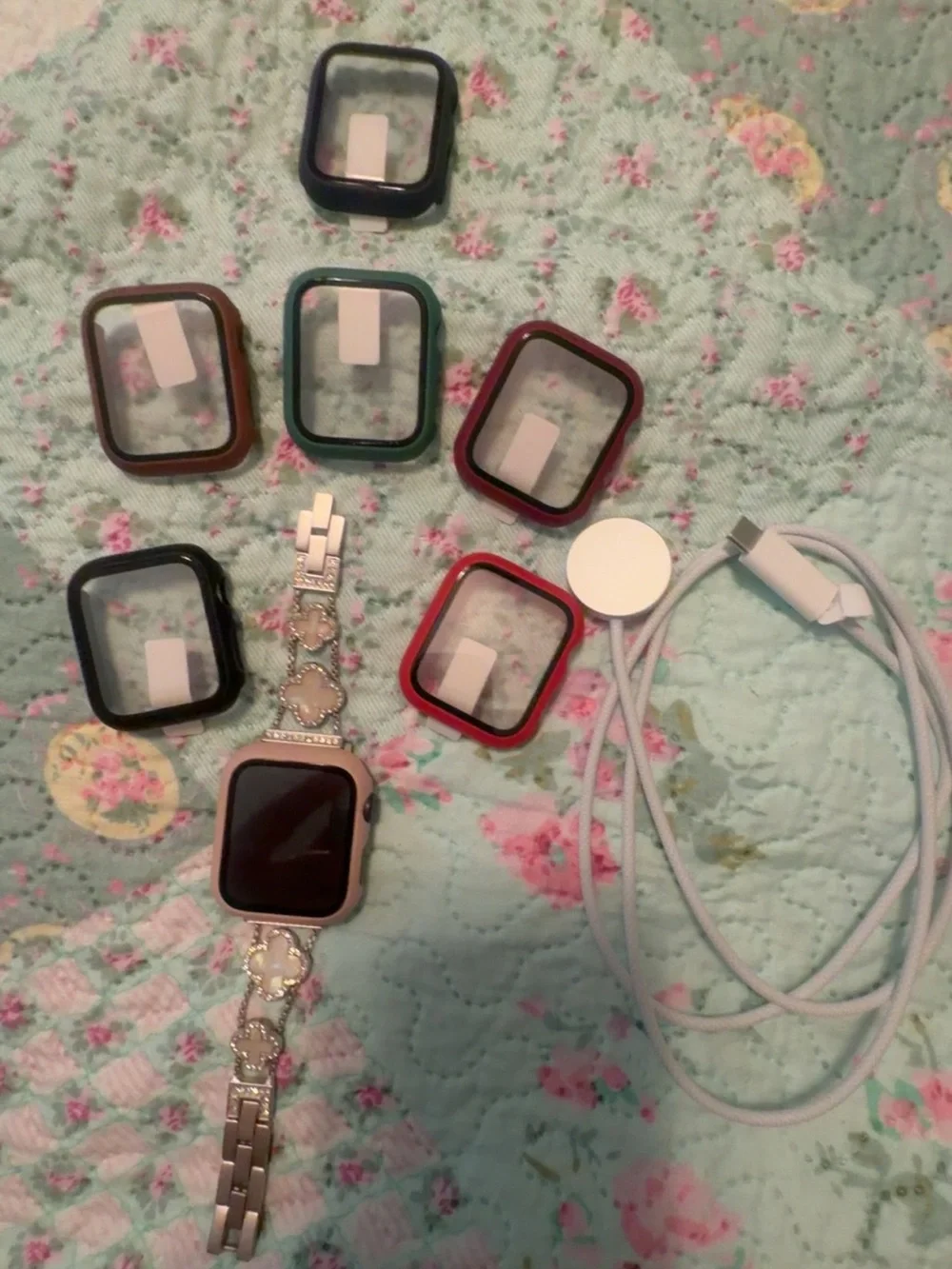 Silver Smartwatch with Multiple Colored Protective Cases and Charger